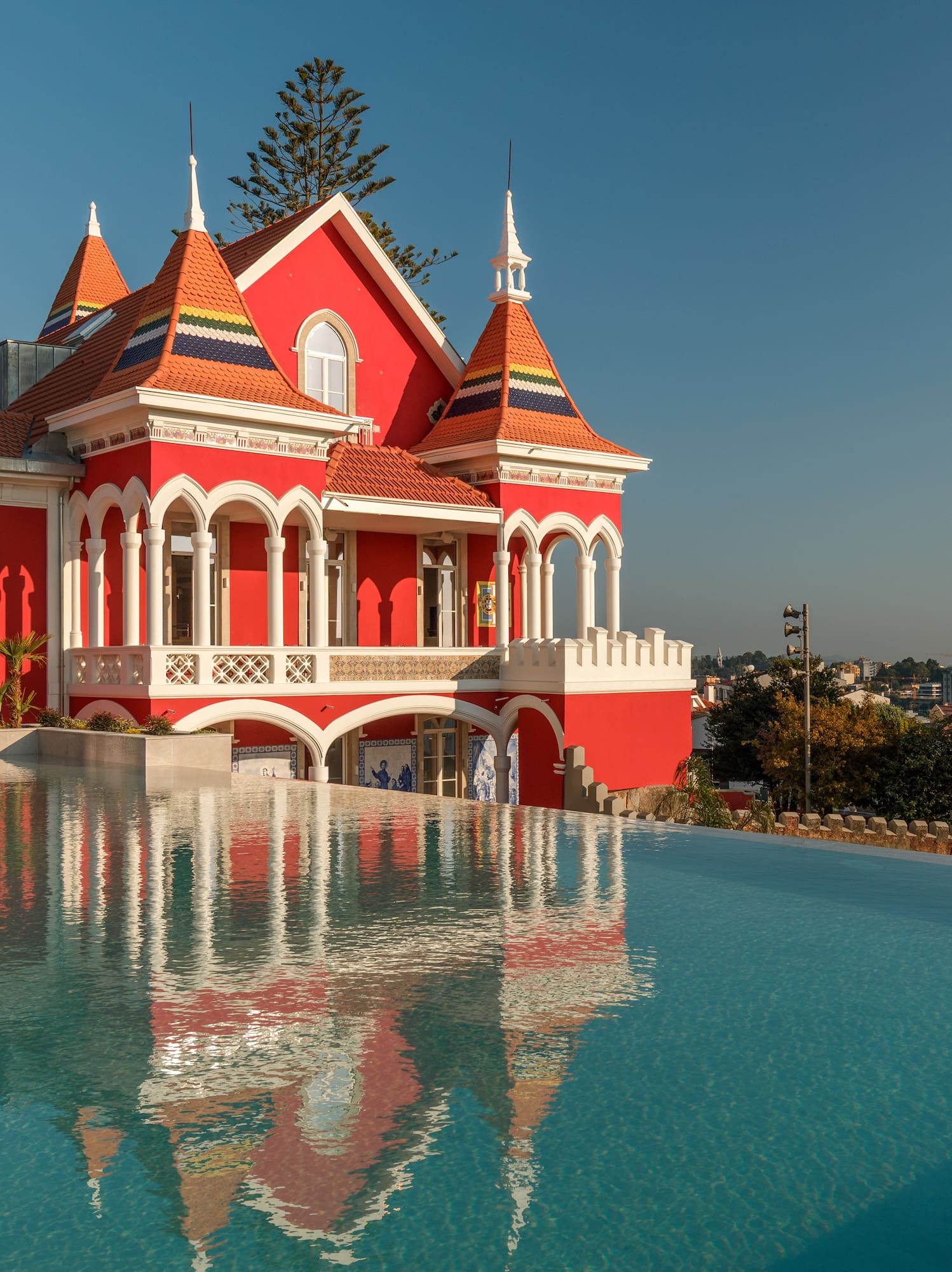 a pool of water next to a red house