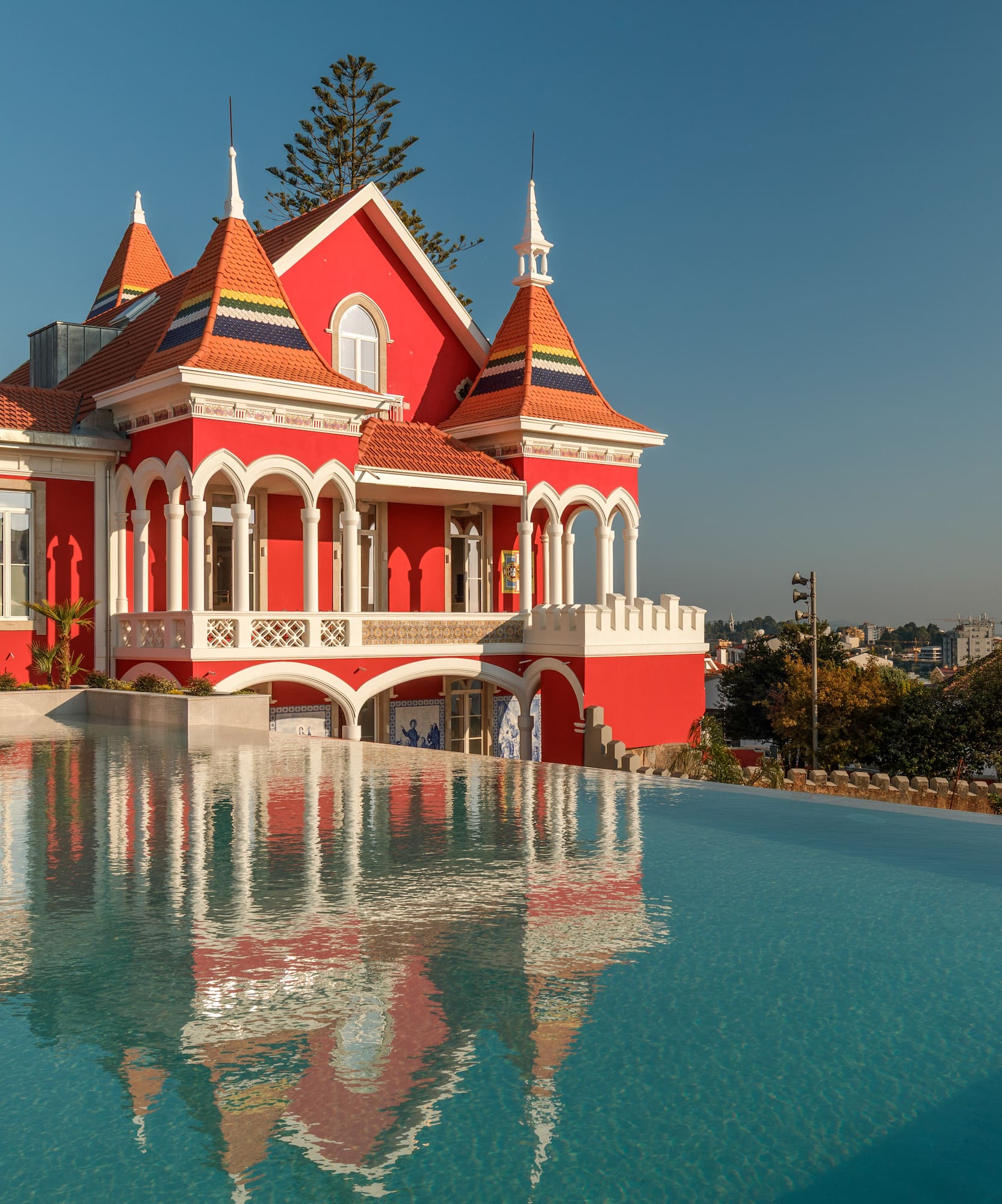 a pool of water next to a red house