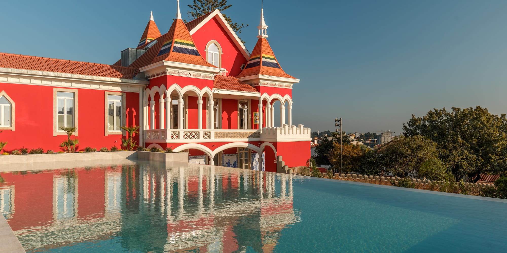 a pool of water next to a red house