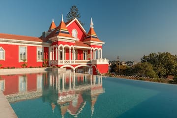 a pool of water next to a red house