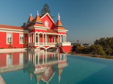 a pool of water next to a red house