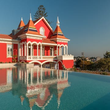 a pool of water next to a red house