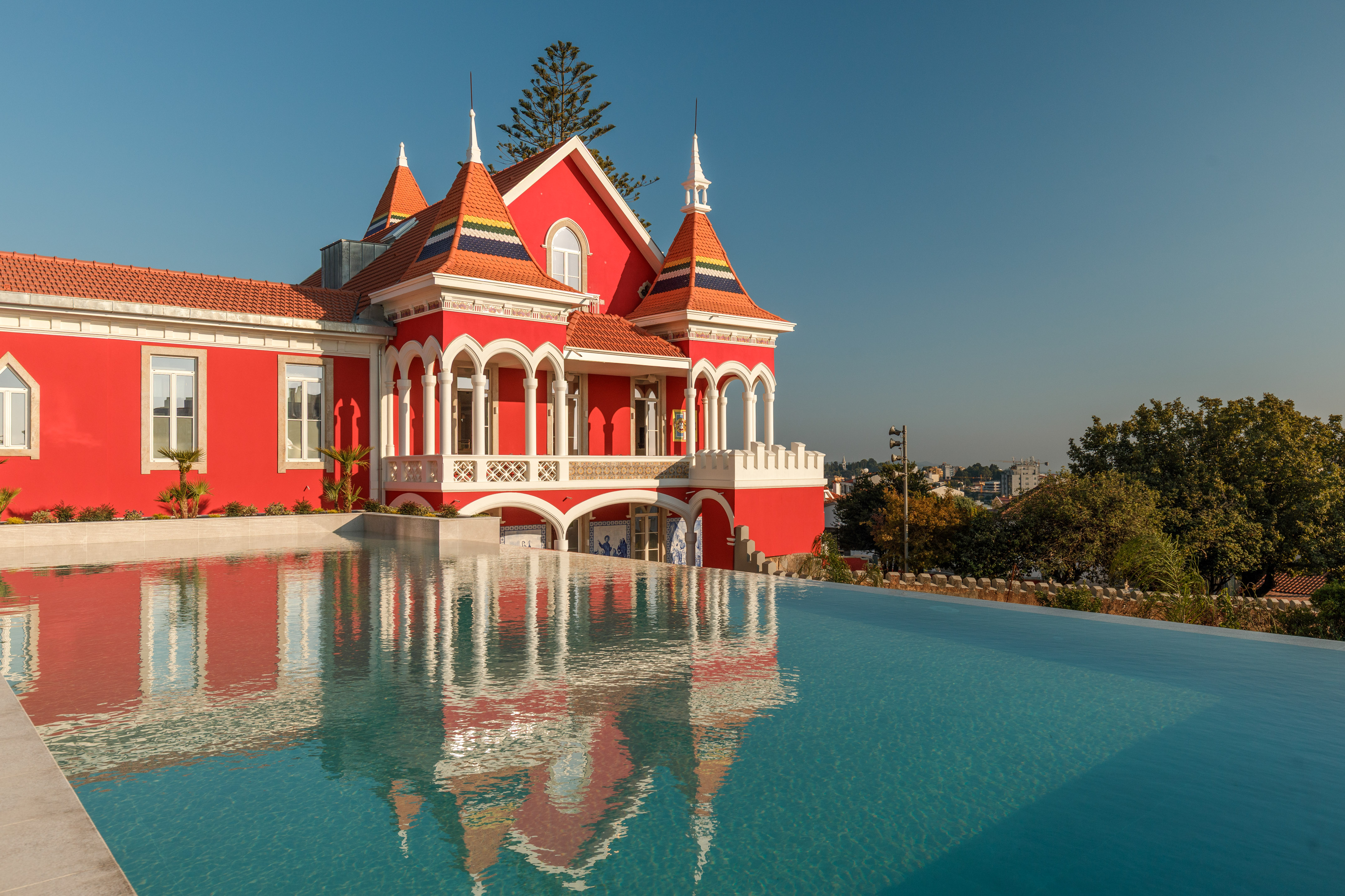 a pool of water next to a red house