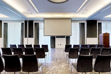 a room with chairs and a projector screen