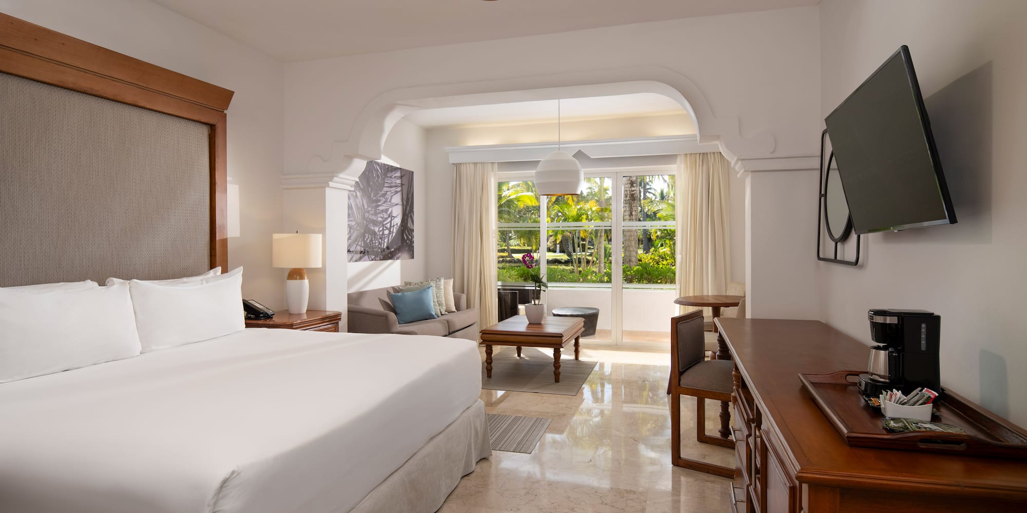 a room with a bed and a television