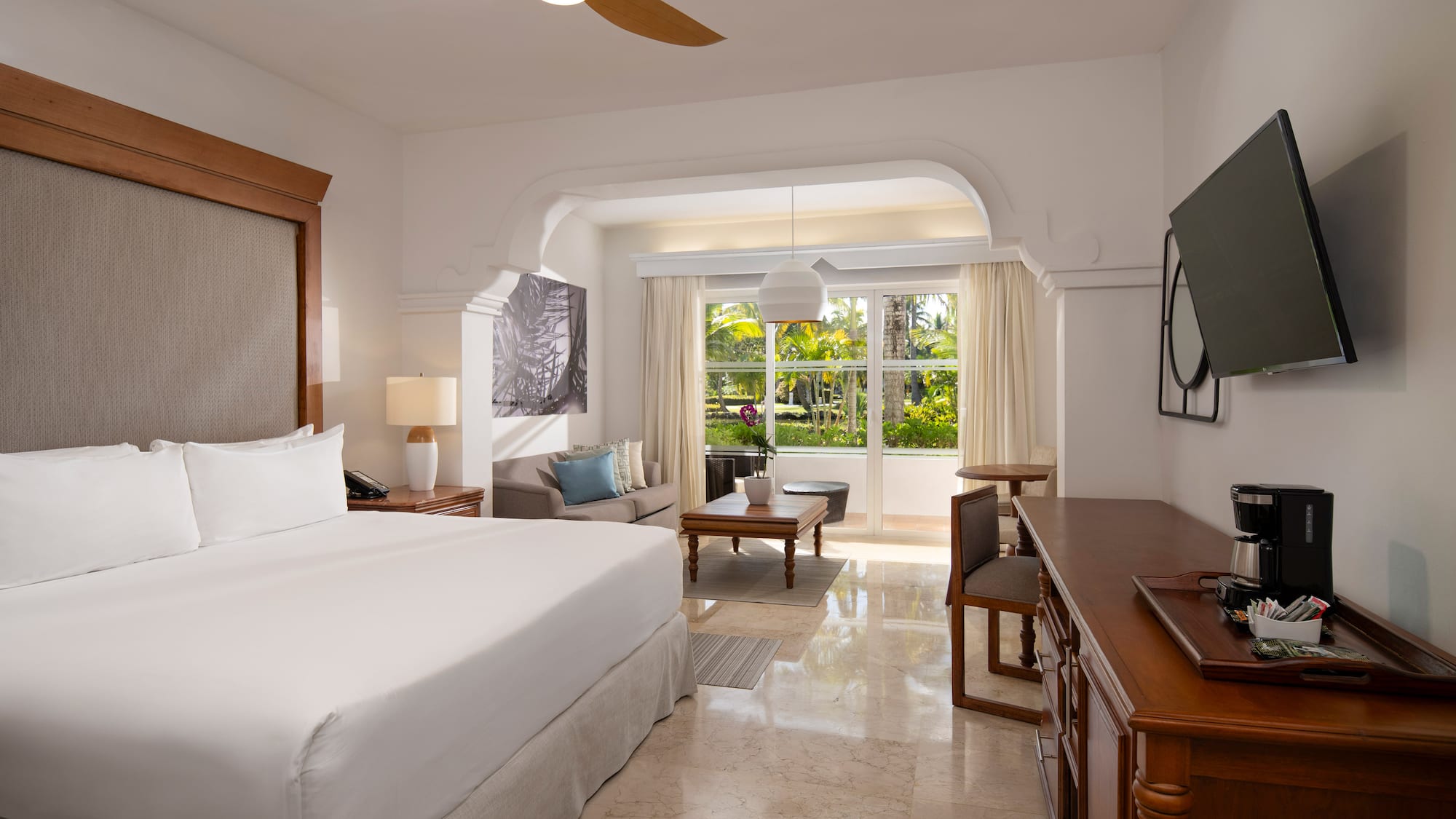 a room with a bed and a television