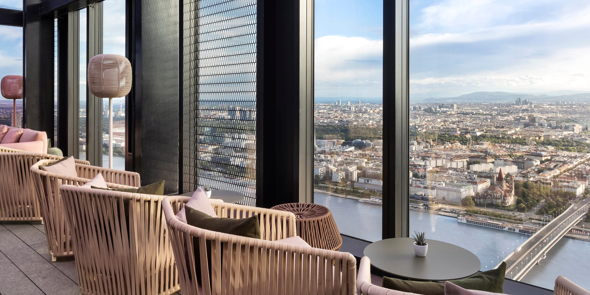 a room with a view of a city and a river