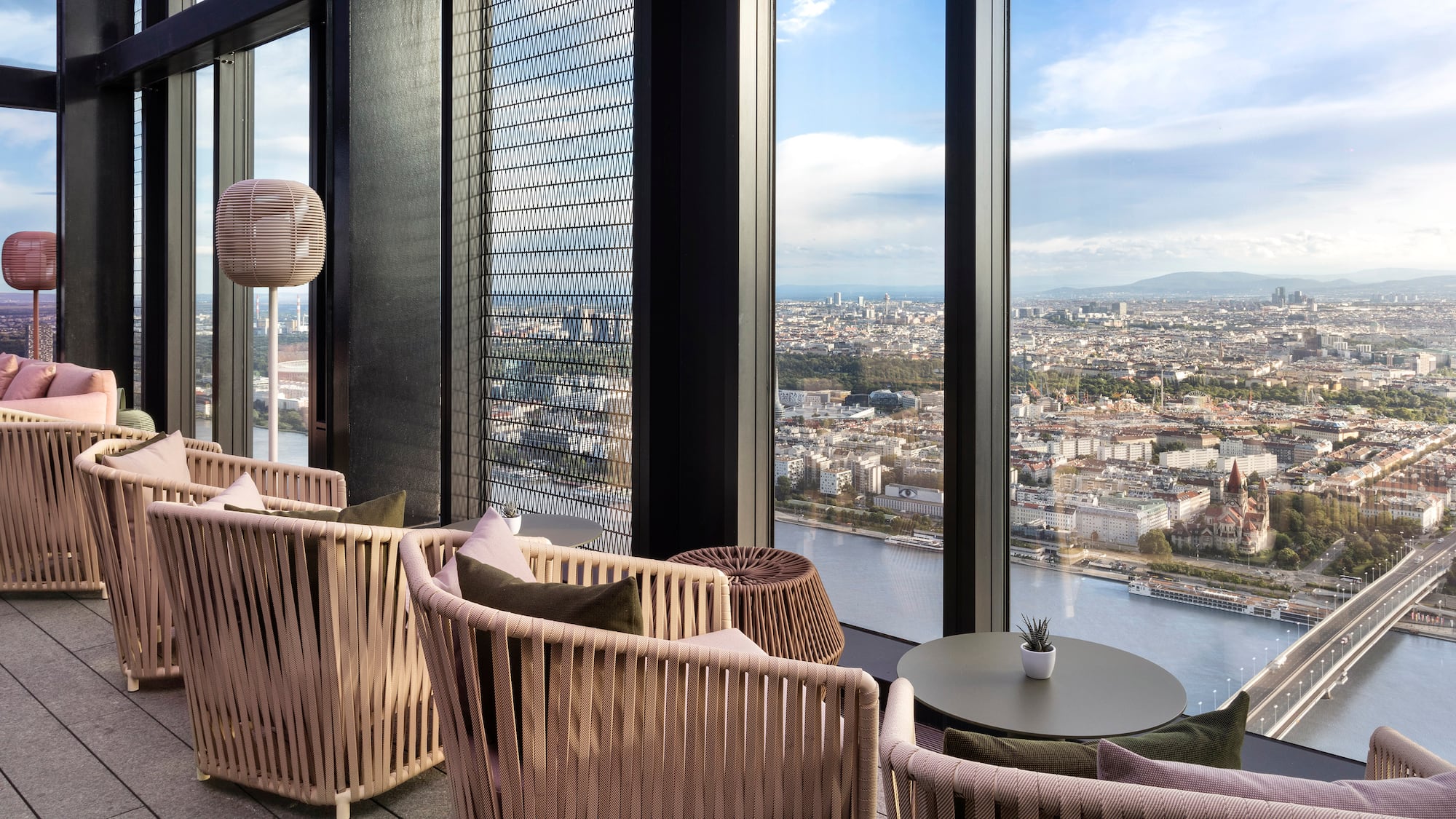 a room with a view of a city and a river