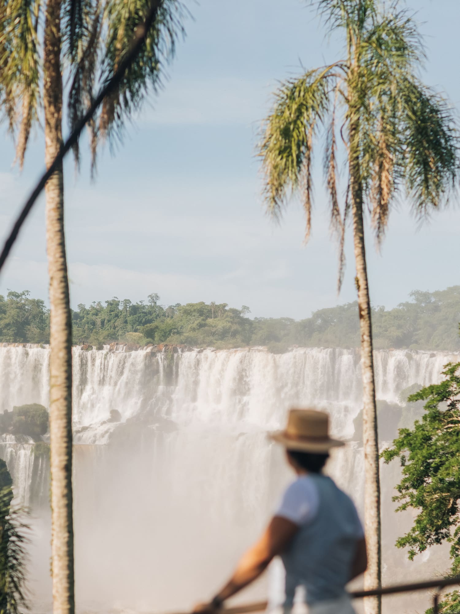 a woman standing in front of a waterfall