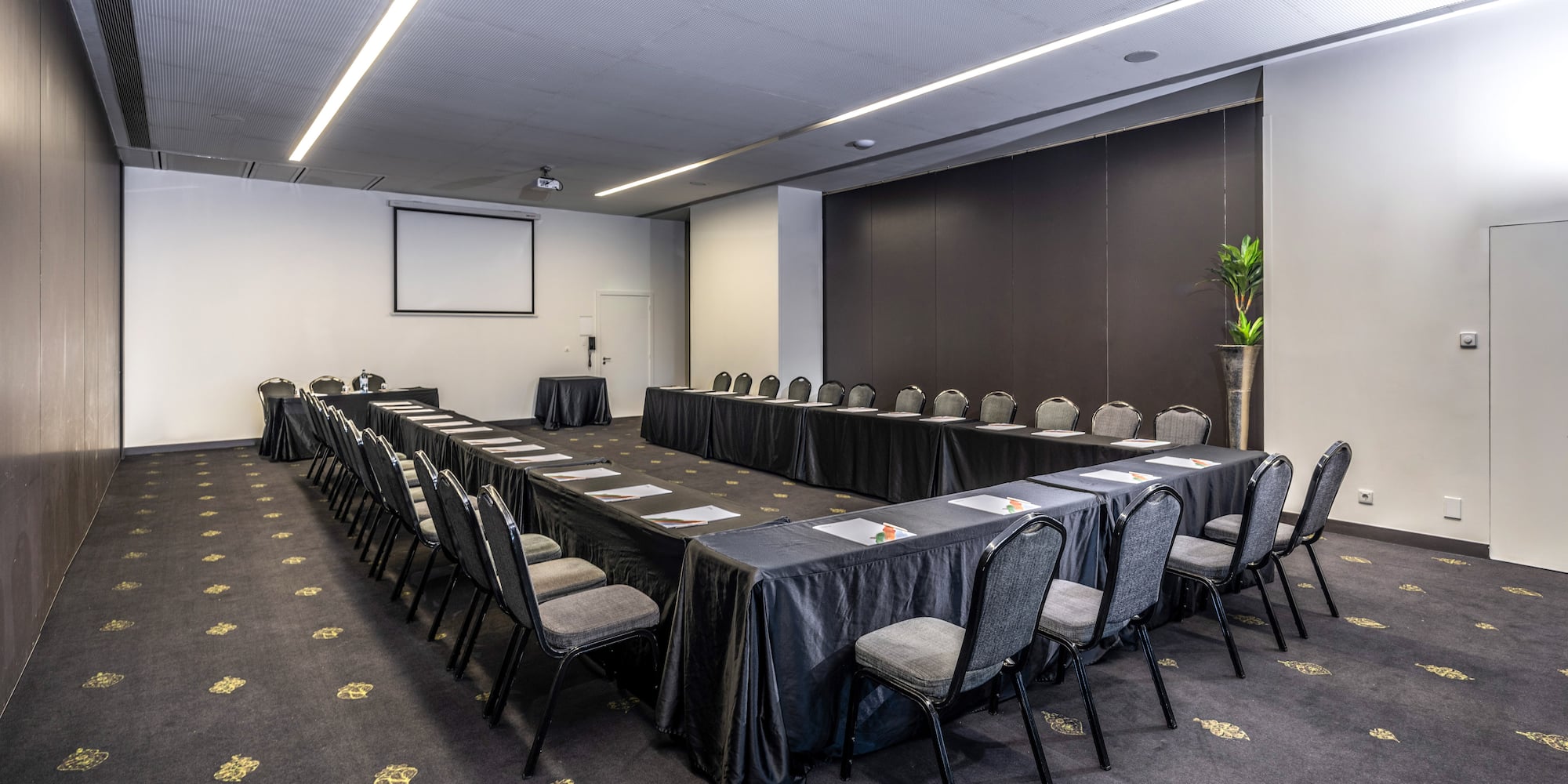 a room with a long table and chairs