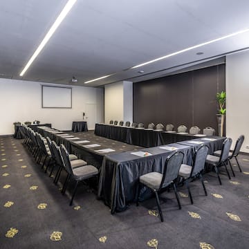 a room with a long table and chairs