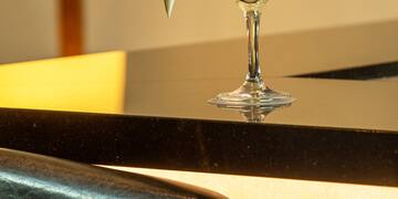 a glass with a drink and a cone on a counter