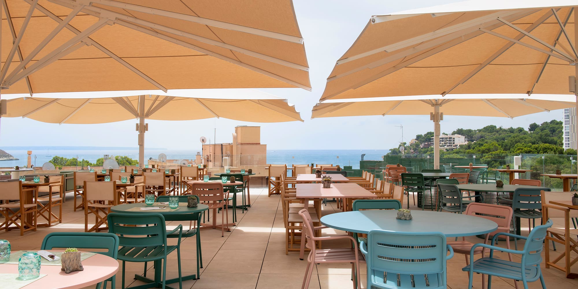 a patio with tables and umbrellas