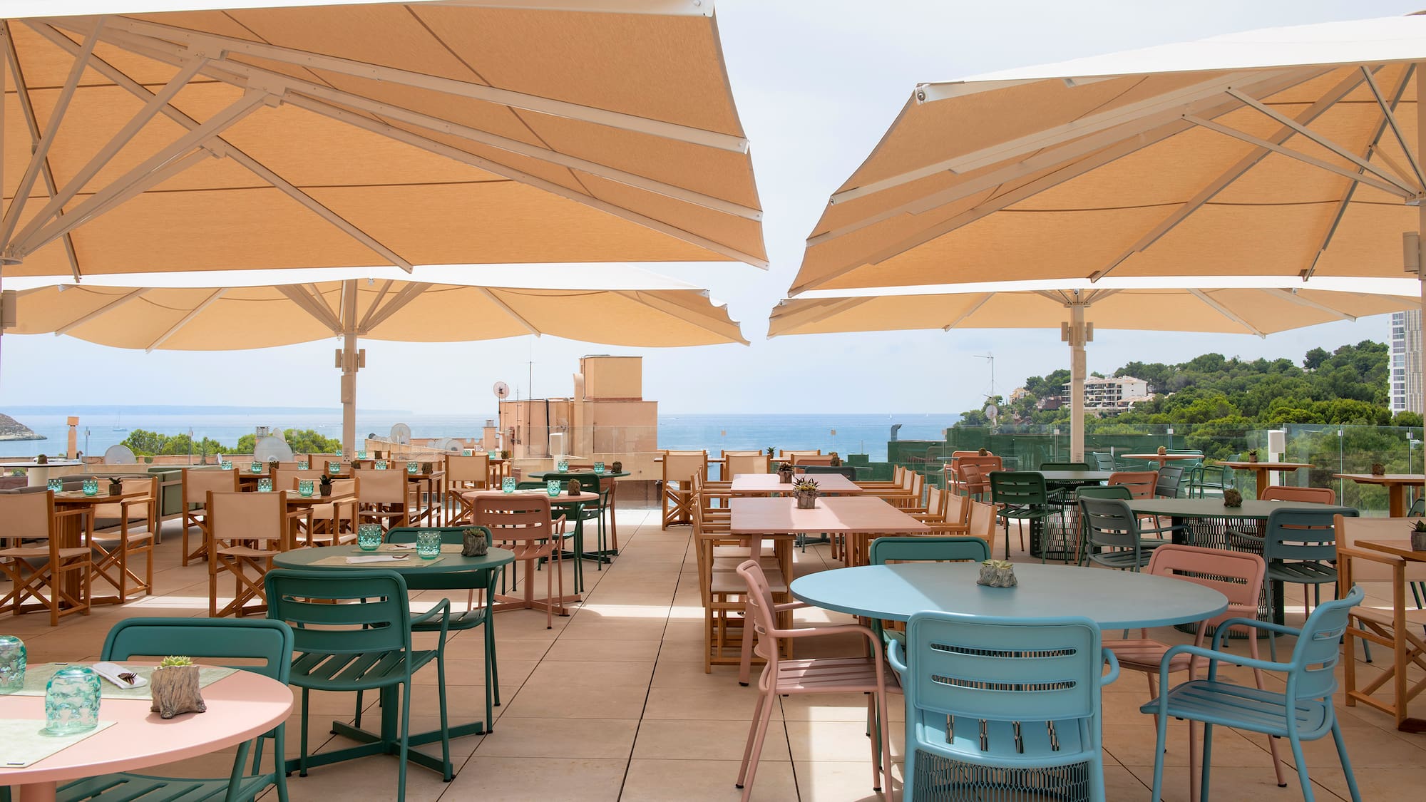 a patio with tables and umbrellas