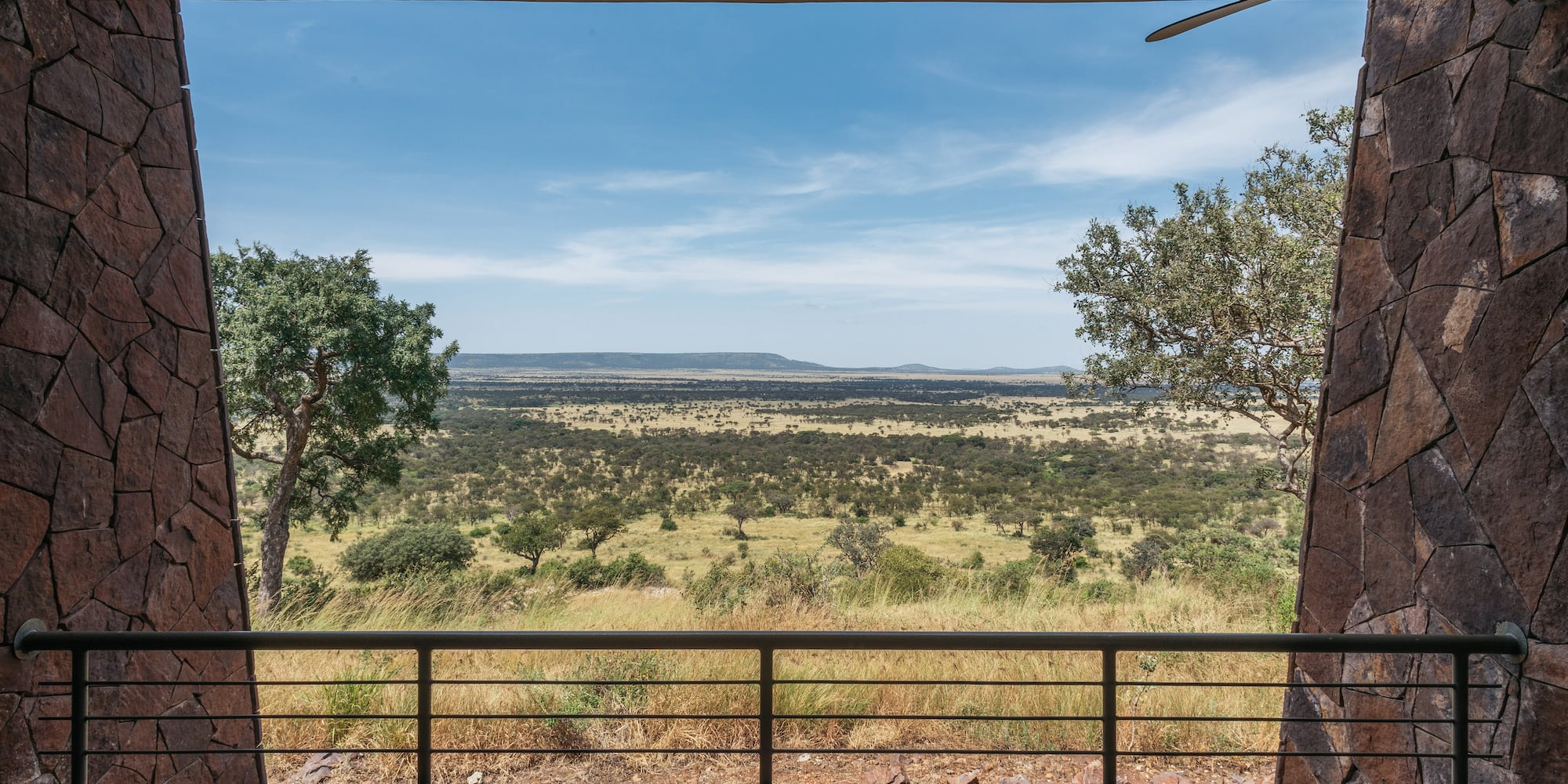 African safari lodge balcony view of vast savanna landscape.