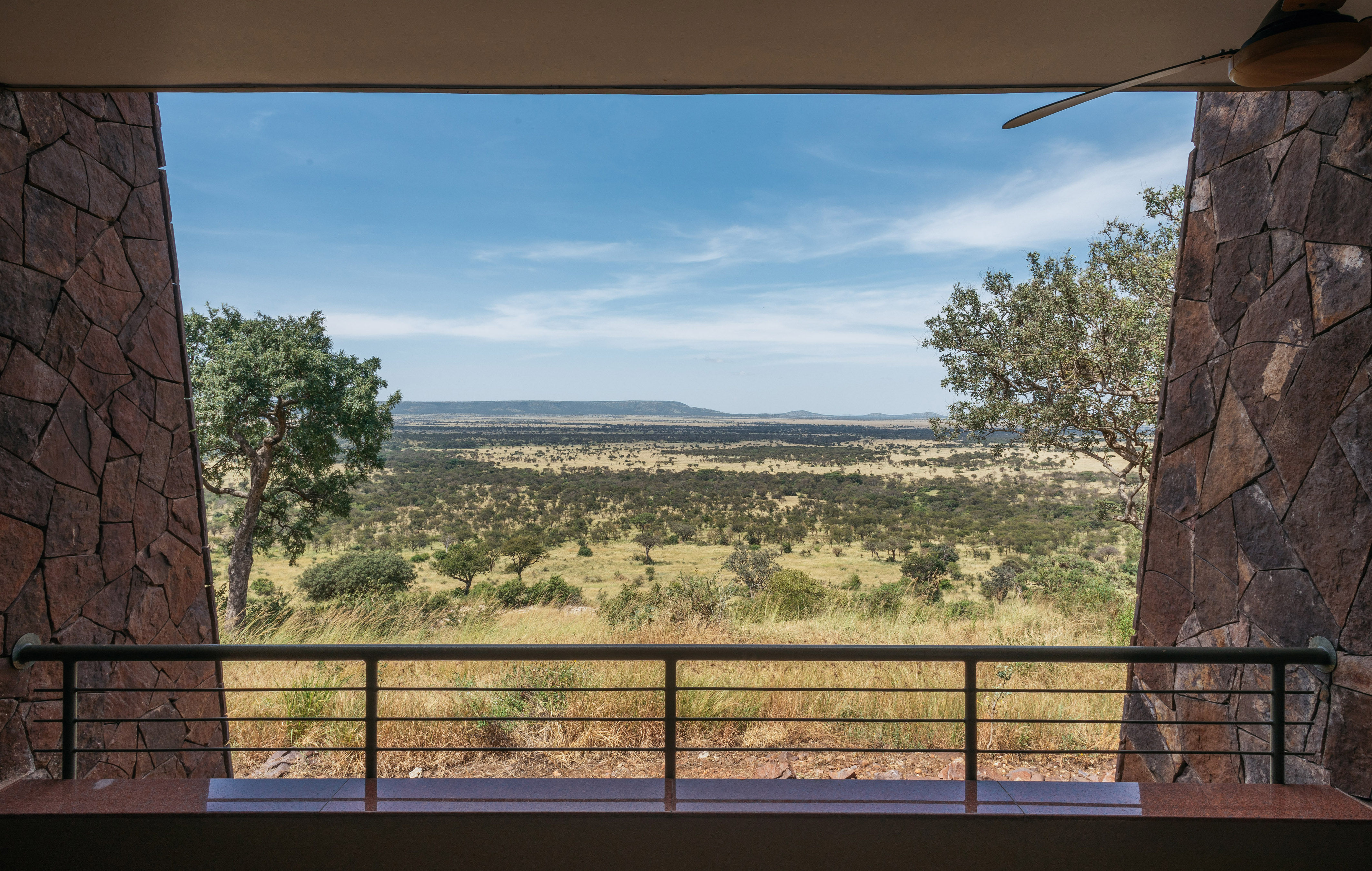 African safari lodge balcony view of vast savanna landscape.