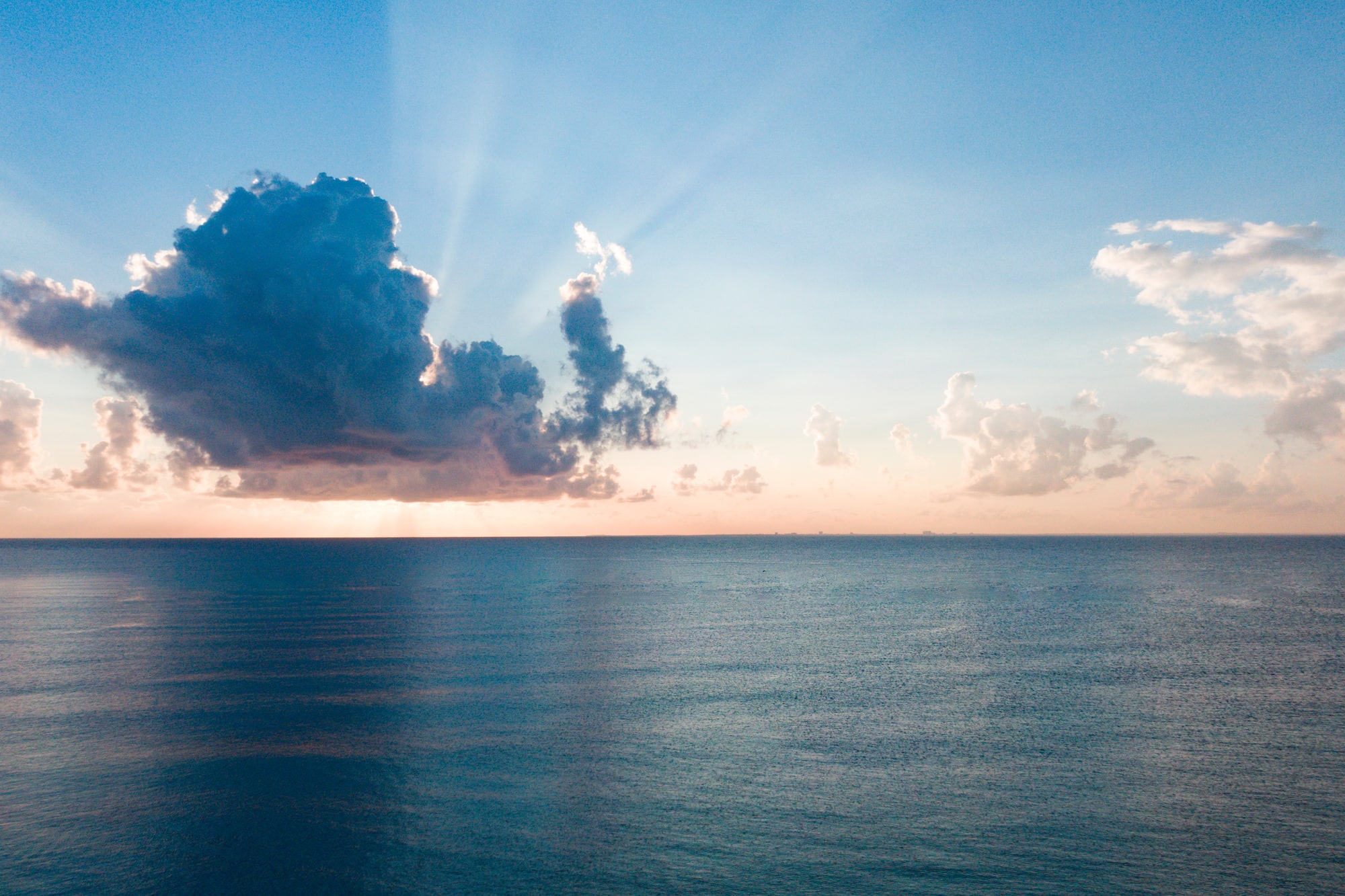 a large body of water with clouds in the sky
