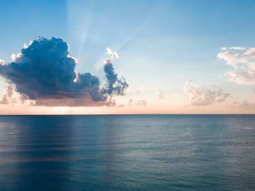 a large body of water with clouds in the sky