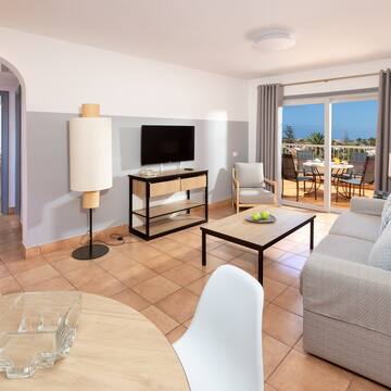 a living room with a television and a table