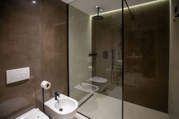 a bathroom with a shower and toilet