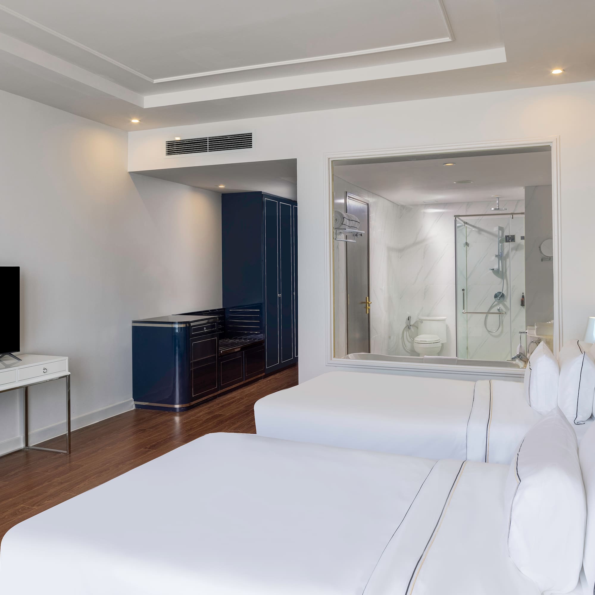 a room with two beds and a tv