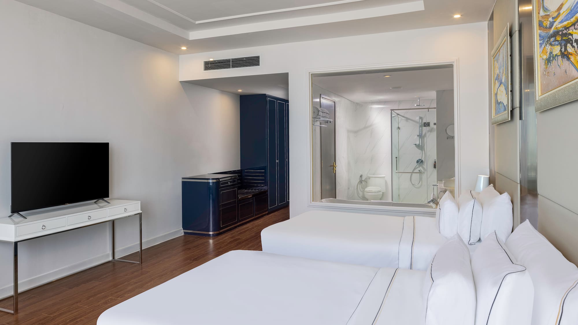 a room with two beds and a tv