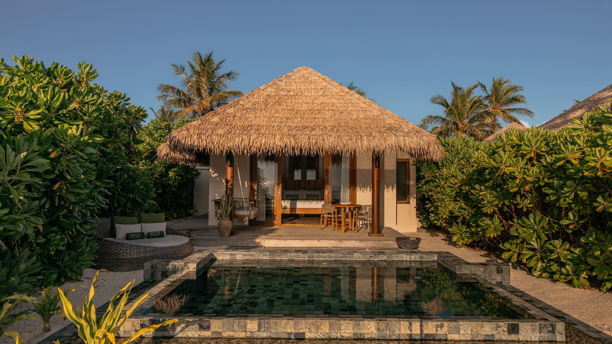 a bed with green and white pillows