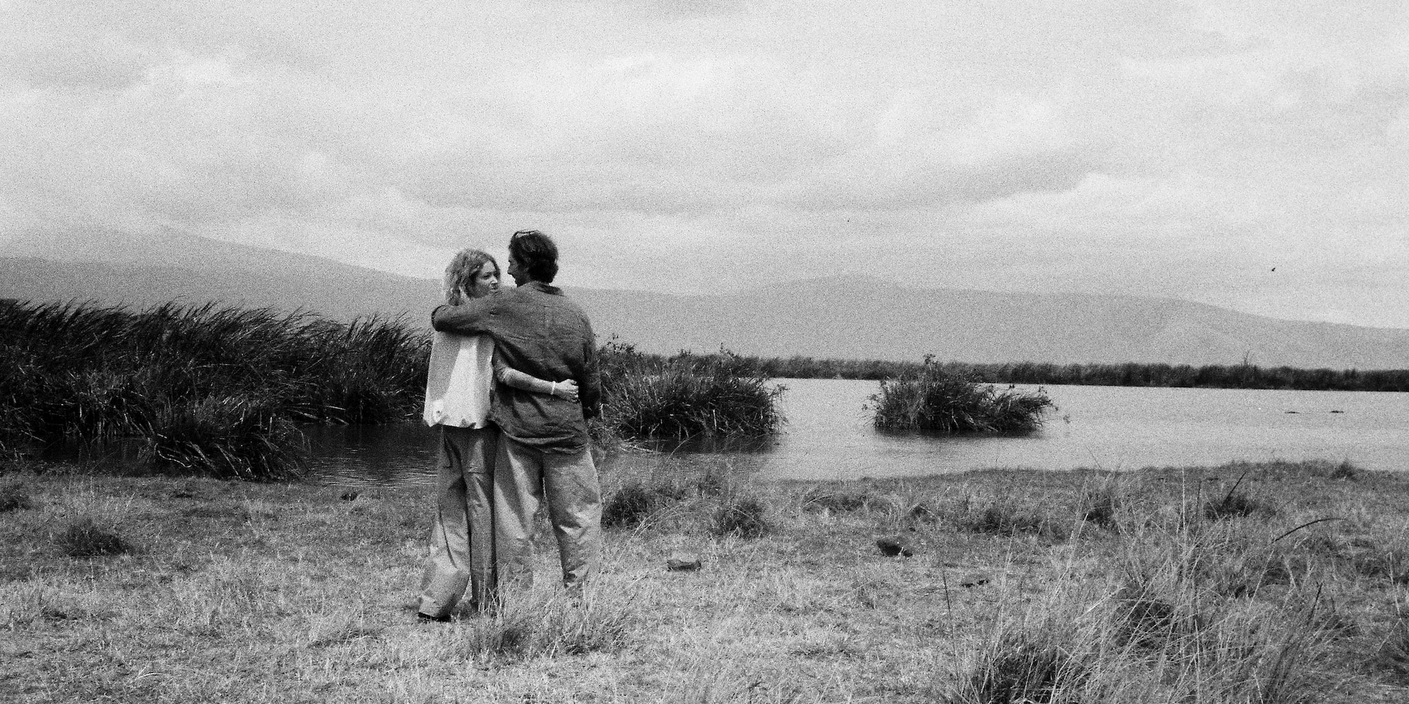 a man and woman hugging in a field