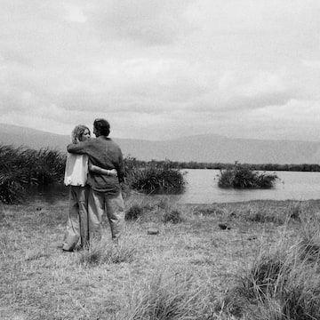 a man and woman hugging in a field