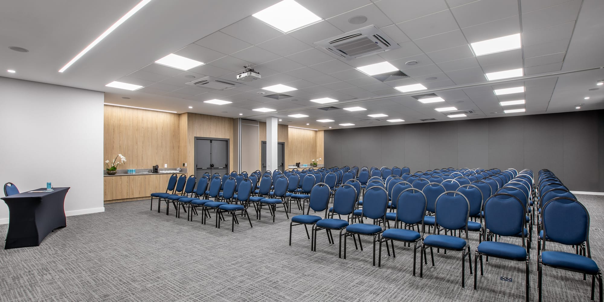 a room with rows of blue chairs