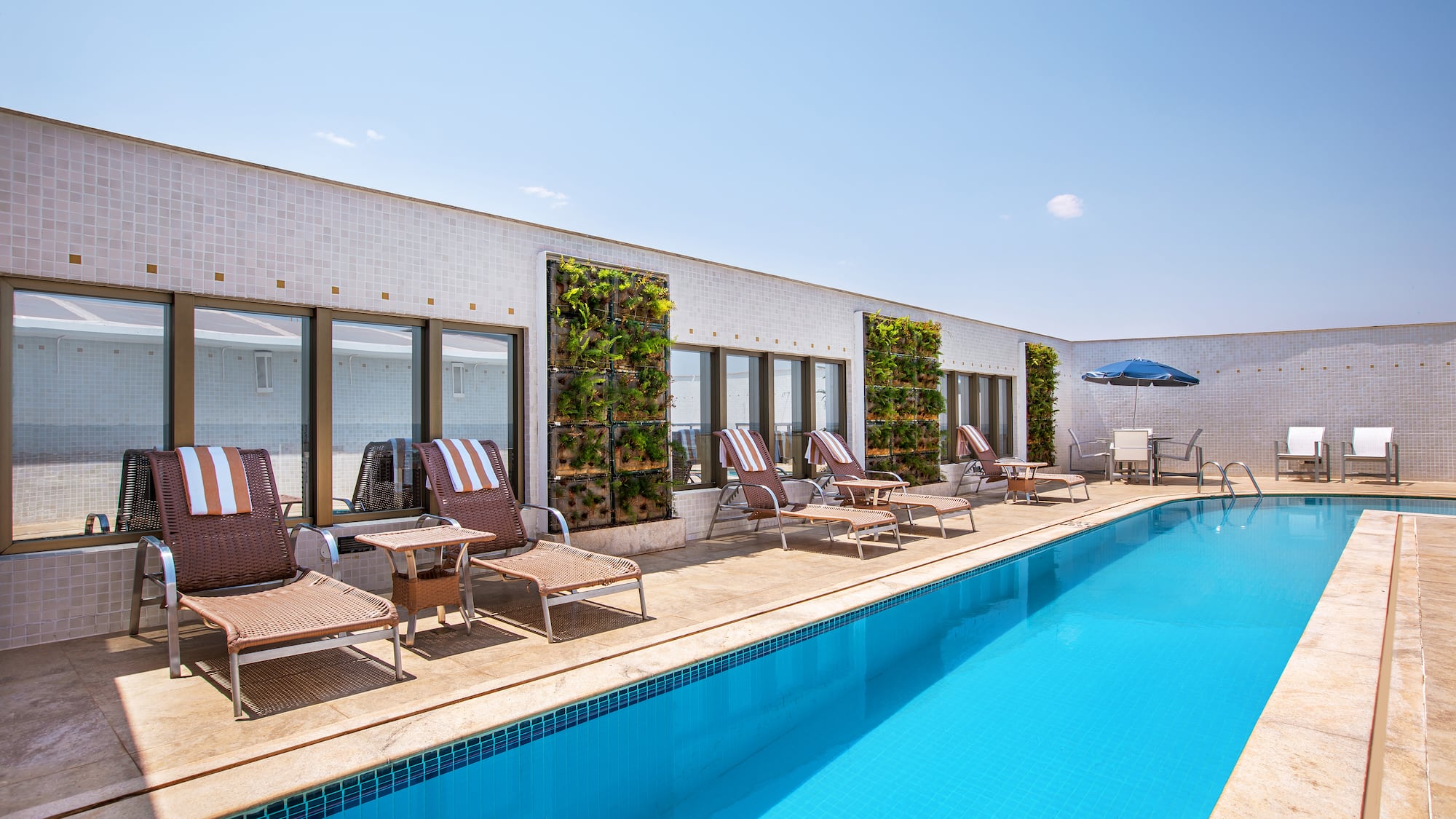 a pool with chairs and umbrellas