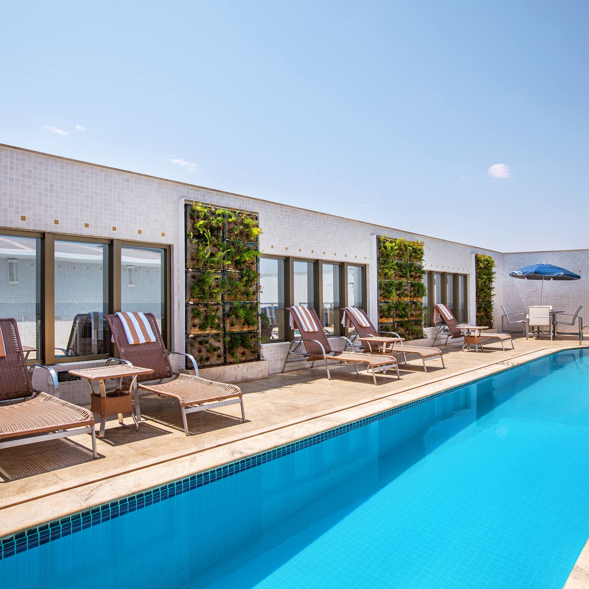 a pool with chairs and umbrellas