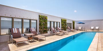 a pool with chairs and umbrellas