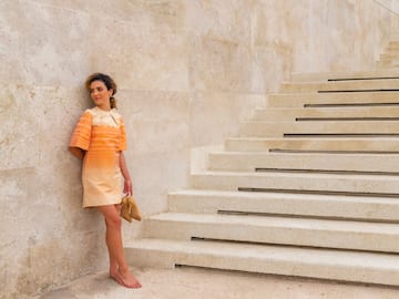 a woman leaning against a wall