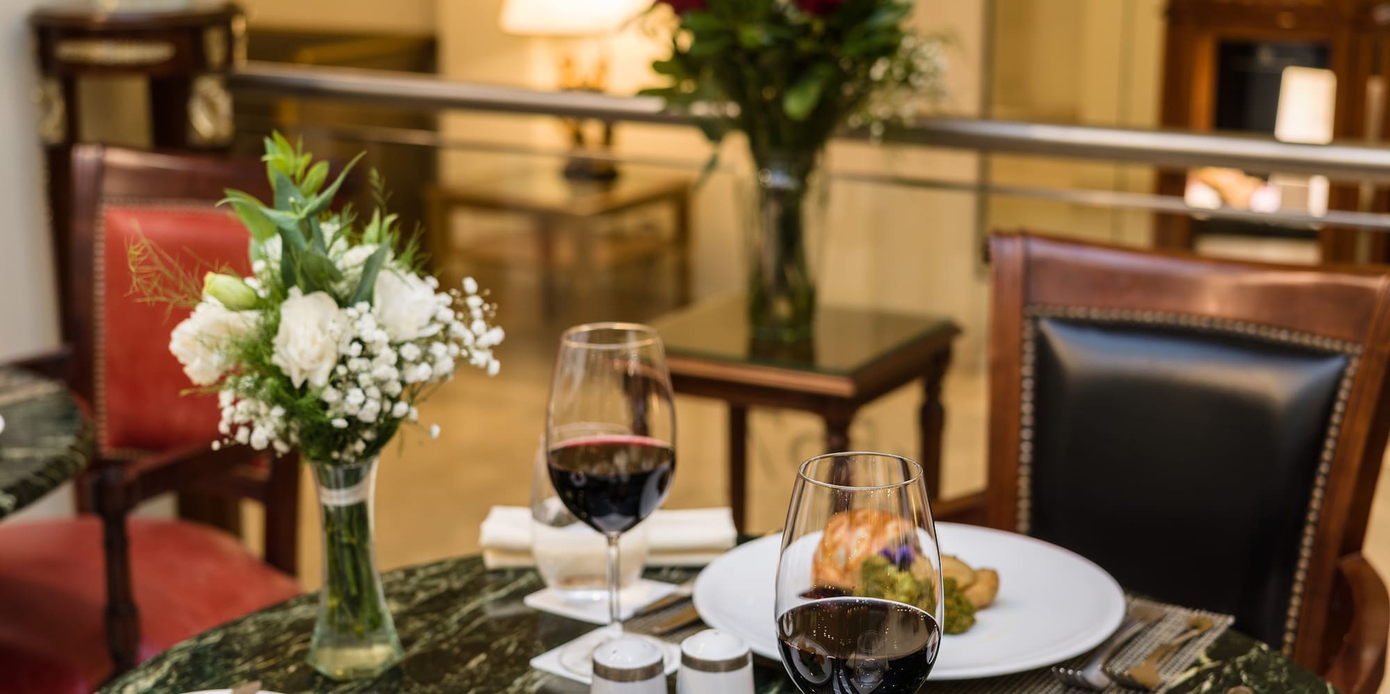 a table with food and wine glasses