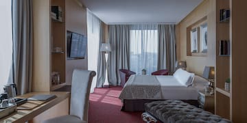 a room with a bed and a tv