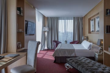 a room with a bed and a tv