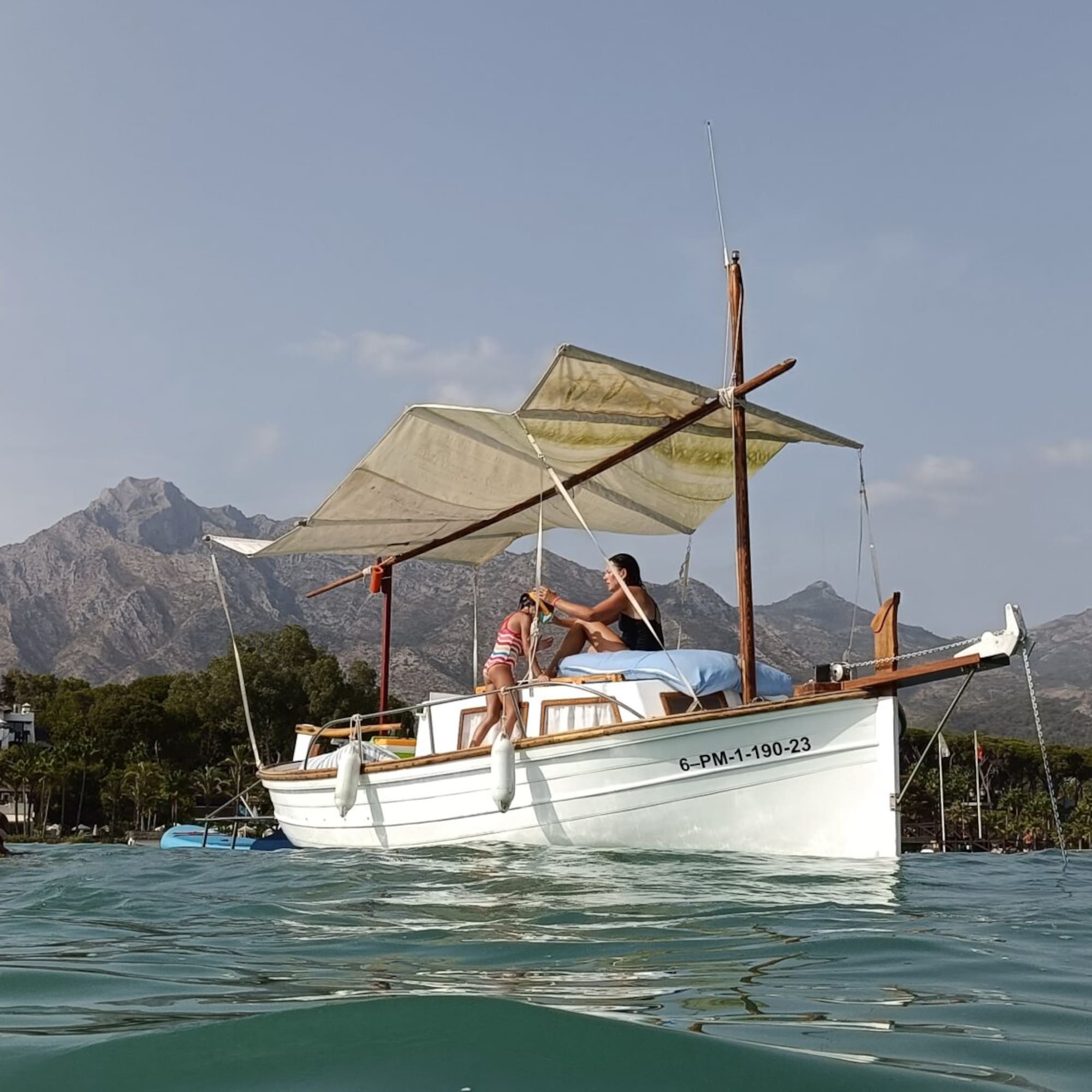 a couple of people on a boat in the water