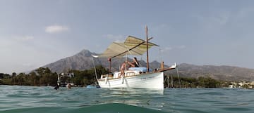 a couple of people on a boat in the water
