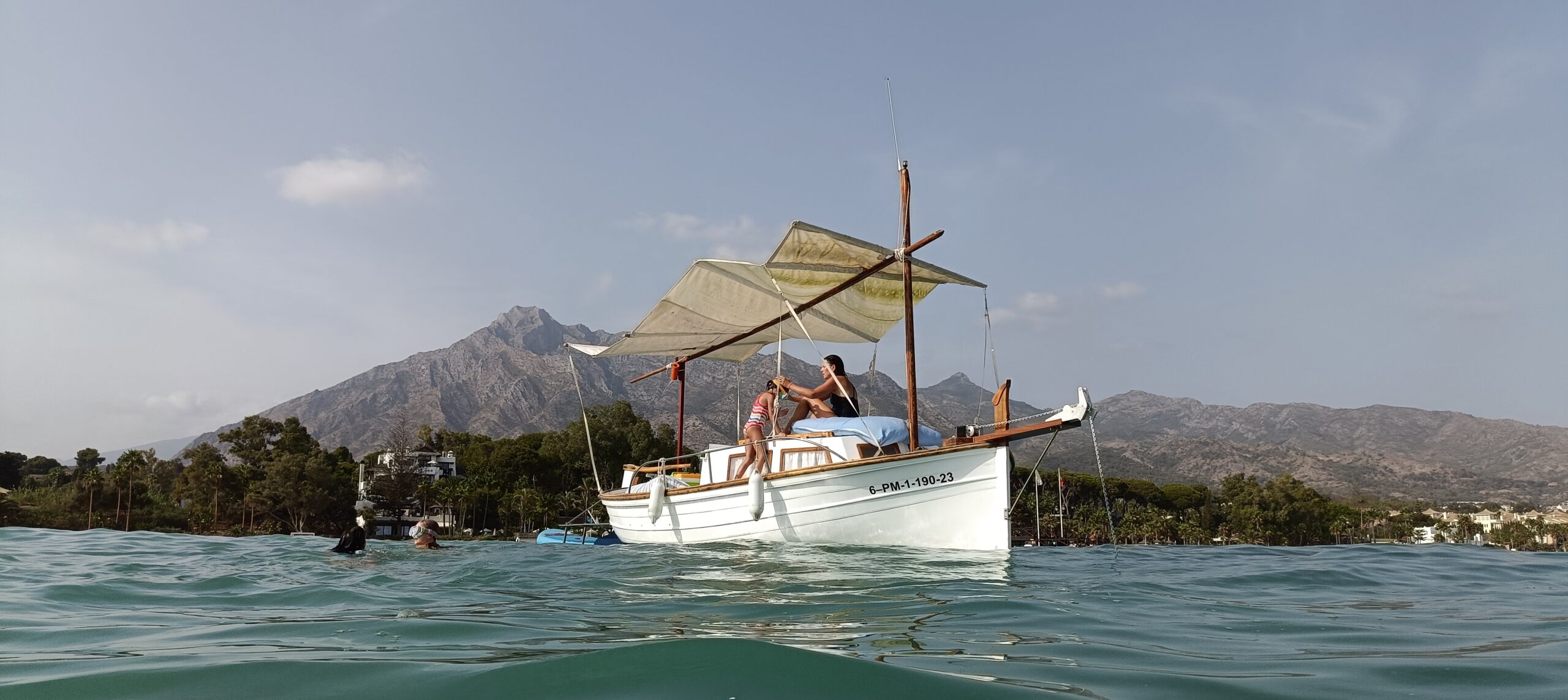 a couple of people on a boat in the water