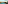 Turquoise bay with sandy beach, green hills, and coastal resort hotels.