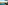 Turquoise bay with sandy beach, green hills, and coastal resort hotels.