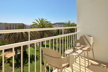 a balcony with chairs and table