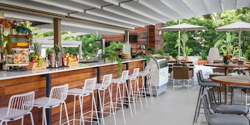 a bar with chairs and tables