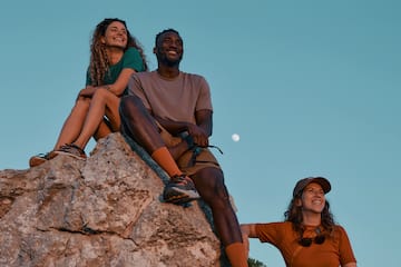 a group of people sitting on a rock