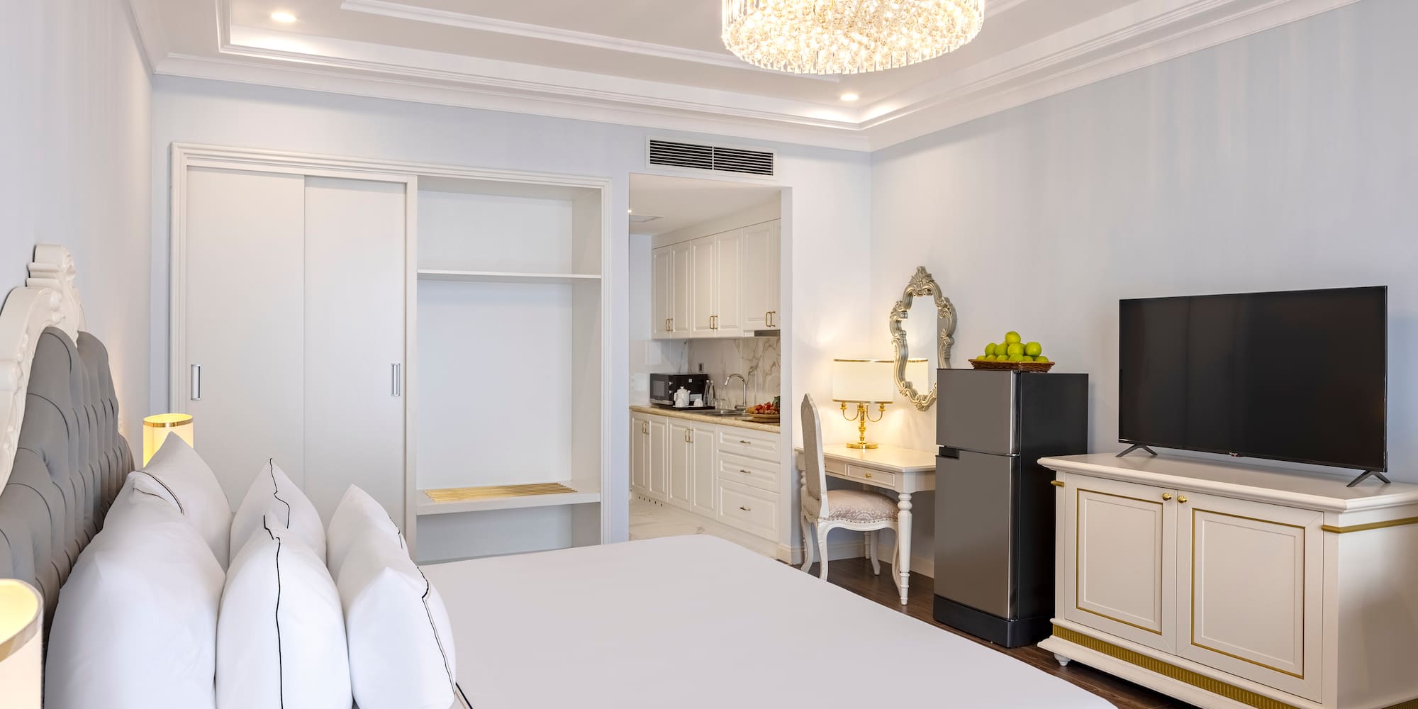 a room with a bed and a refrigerator