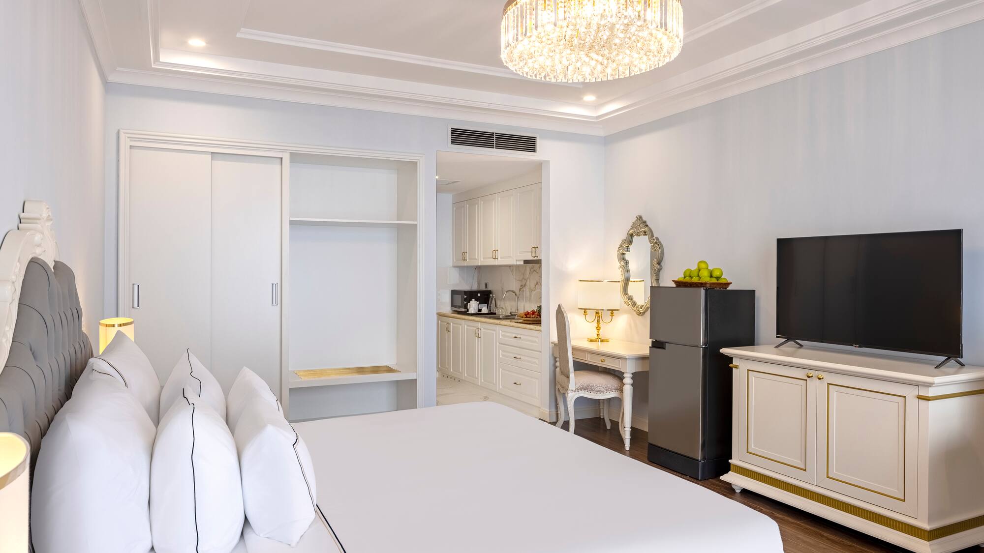 a room with a bed and a refrigerator