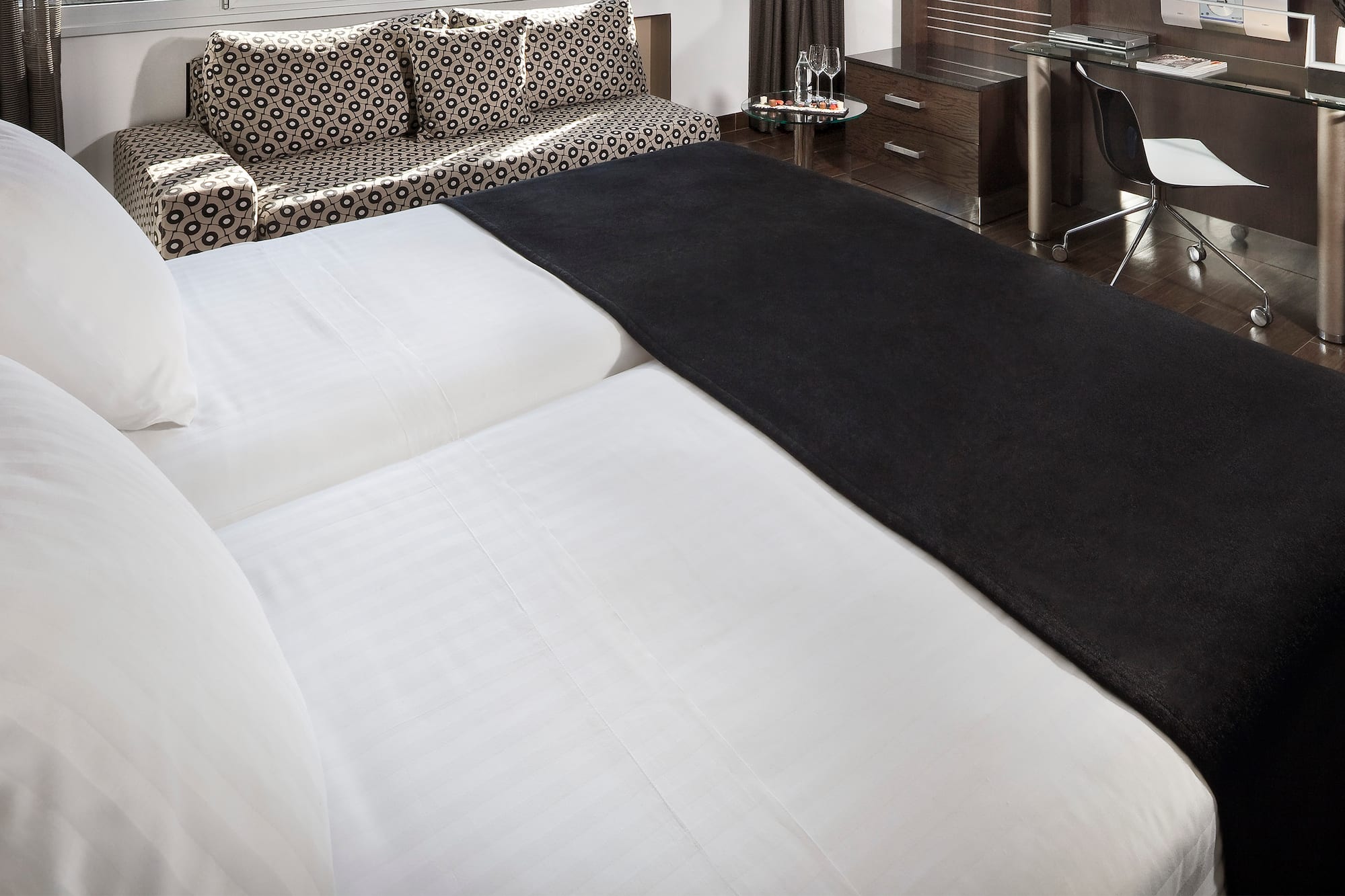 a bed with a black blanket on it