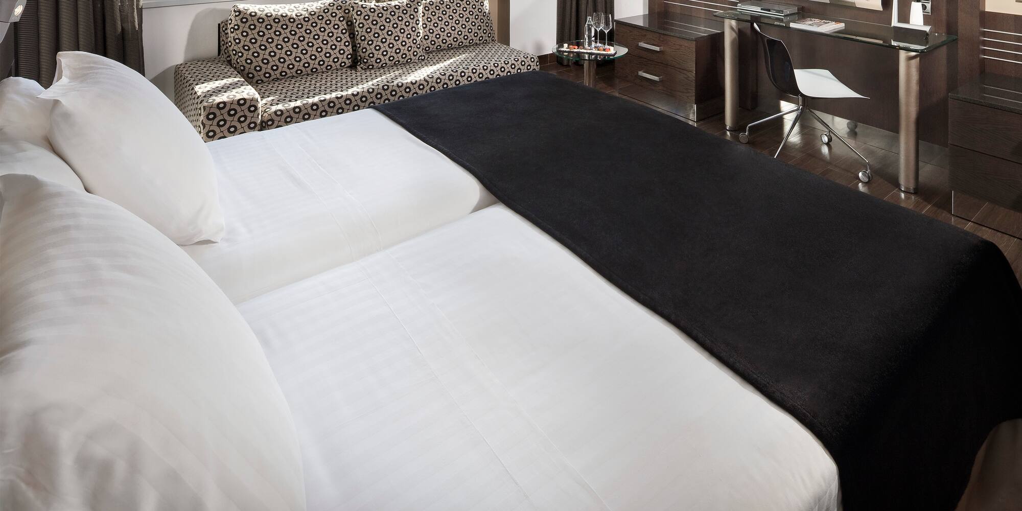 a bed with a black blanket on it