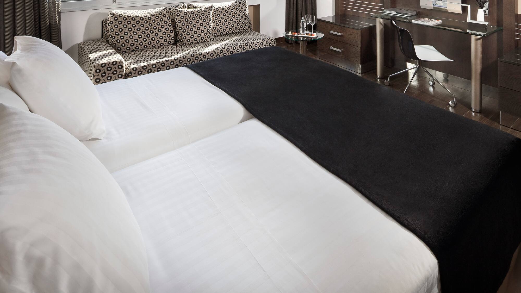 a bed with a black blanket on it